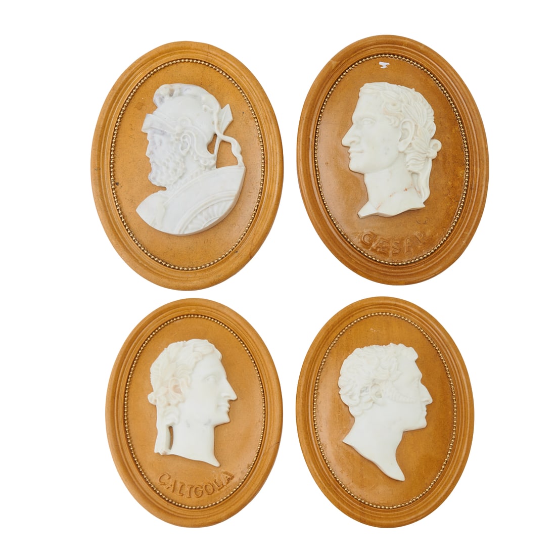 Set of Four Oval Grand Tour Style Marble Portrait Plaques: Set of Four Oval Grand Tour Style Marble Portrait Plaques, the white to grey portraits in low relief on black flecked ocher surrounds, with gilt bead decoration within grooved rims.{Approximate
