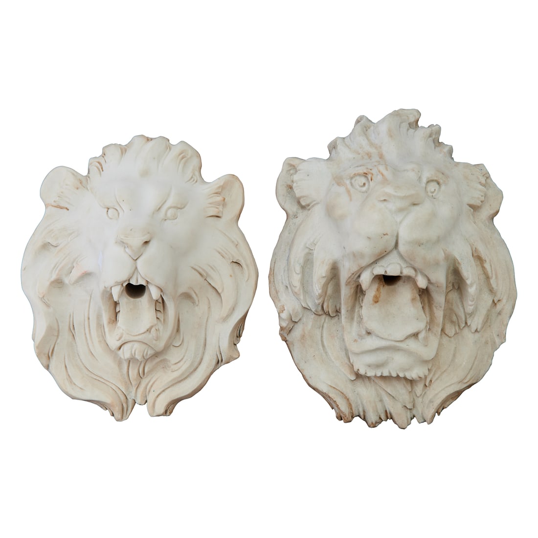 Two Italian Carrara Marble Carvings of Lion's Heads: Two Italian Carrara Marble Carvings of Lions Heads, designed as flat backs, with holes in mouths agape, to be used as fountain fixtures.{Approximate dimensions:; 13 1/2" H. x 9 1/2" W. x 5 1/4" D.}.