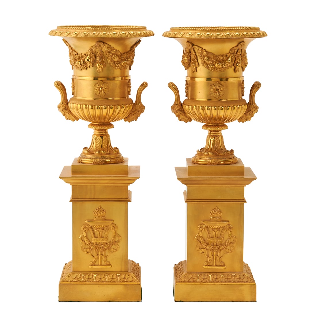 Pair of Empire Style Gilt Brass Urns: Pair of Empire Style Gilt Brass Urns,;each Campana shaped, with everted milled rims, with scrolling vine leaves and grape clusters, to sides, fitted with reeded handles. each decorated with two