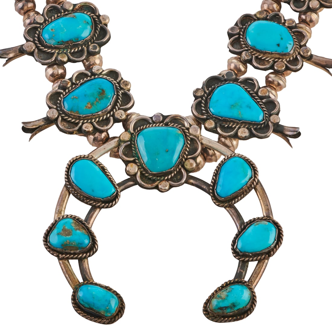 Native American Navajo Turquoise, Silver Squash Blossom Necklace: Native American Navajo Turquoise, Silver Squash Blossom Necklace. Featuring one central turquoise cabochon, silver naja measuring approximately 79 x 85 mm, accented by ten turquoise cabochon, silver s