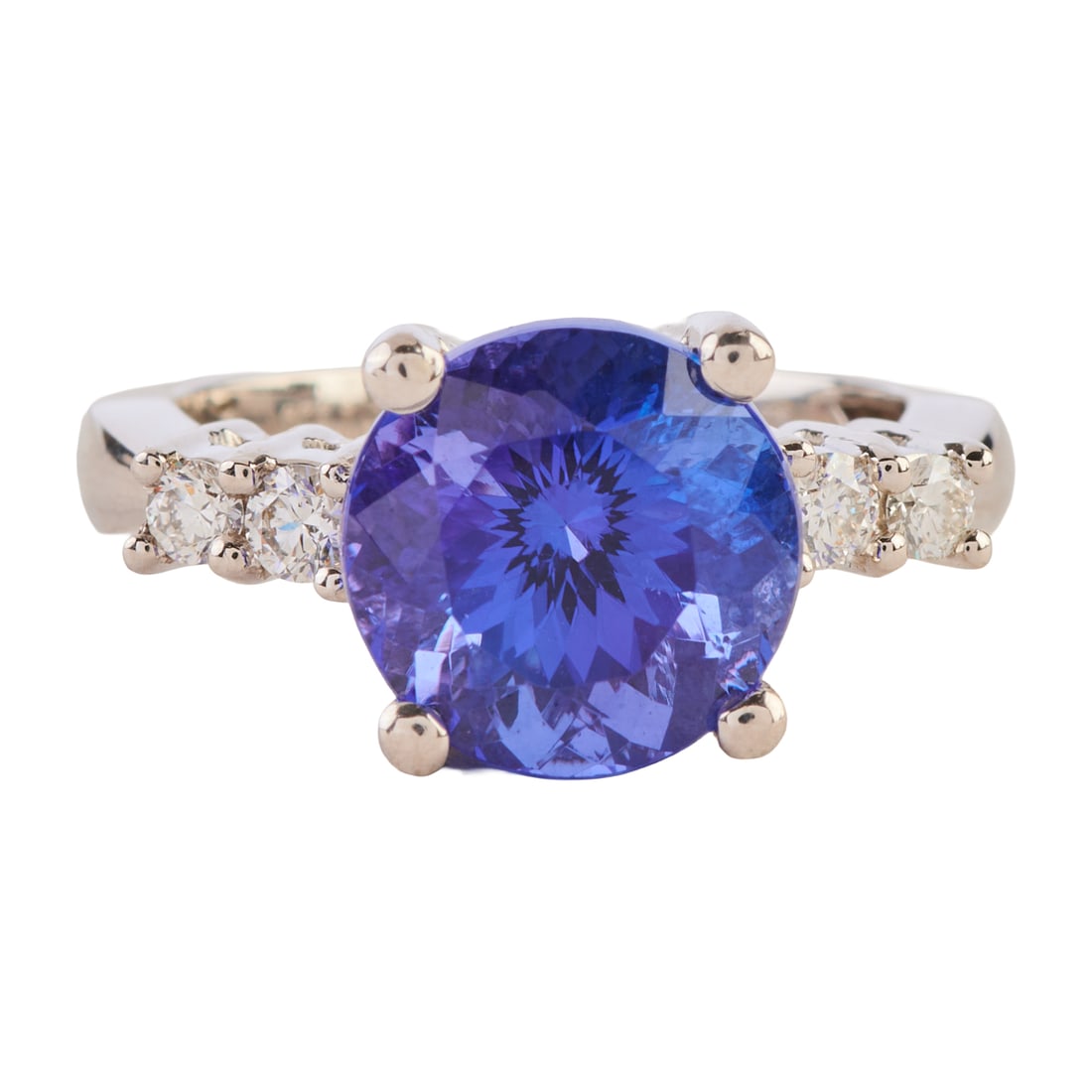 Rhapsody Tanzanite, Diamond, Platinum Ring: Rhapsody Tanzanite, Diamond, Platinum Ring. Featuring one round-cut tanzanite weighing approximately 5.20 cts., accented by four full-cut diamonds weighing a total of approximately 0.30 cttw., set in