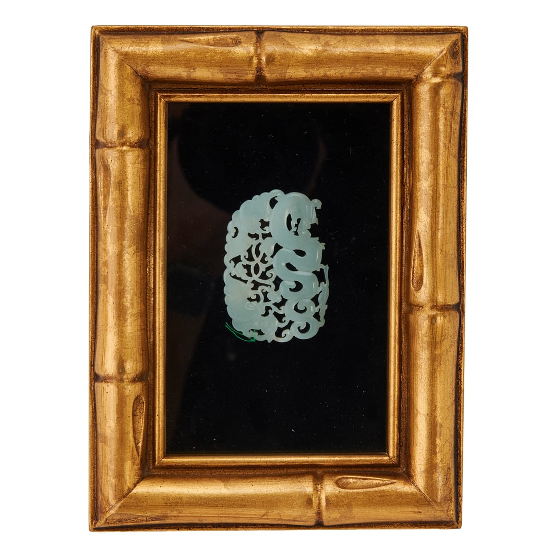 A Chinese Jade Dragon Form Pendant, Qing Dynasty: A Chinese Jade Dragon Form PendantQing DynastyWith losses to the edges, accompanied by a box.{Pendant: Height 1 3/4 inches (4.4 cm), width 2 3/8 inches (6 cm); box: Height 5 3/4 inches (14.6 cm), widt