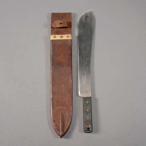 Military Machete by Kitchin: Military Machete by Kitchin, Sheffield, with Broad Arrow Mark and Leather Scabbard 14 1/2-inch long blade with Kitchin Ltd. marking and broad arrow with date 1955. Brown composition grip panels, one m