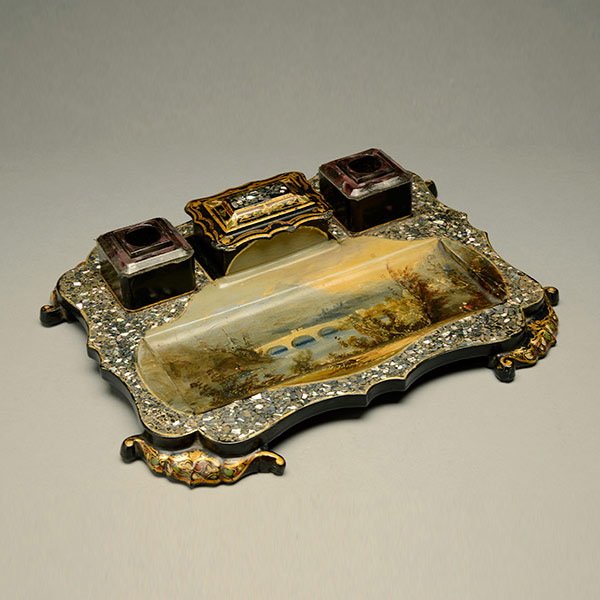 Victorian Papier Mache Desk Stand: Victorian Mother-of-Pearl Inlaid, Stenciled Gilt Ebonized Papier Mache Desk Stand featuring a painted landscape with an aqueduct and fitted with two square glass inkpots {Dimensions of desk stand 1 x 