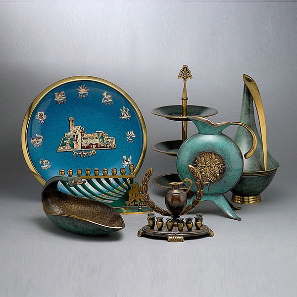 Seven Pieces of Israeli Enameled Metal Work: Collection of Modern Israeli Enameled Metal Work, Including some Judaica: two ewers; a candle holder with wreath; a menorah signed Dayagi; a duck form dish; plaque {diameter 11 1/2 inches}; and a thre