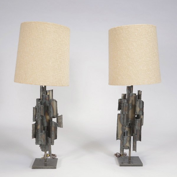 Pair of Mid-Century Brutalistic Lamps.: Pair of Mid-Century Brutalistic Lamps. Both have rattan shades made of woven wool. Measures approximately 49 inches in height, 17 inches in width.