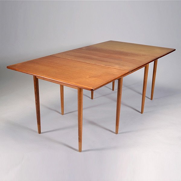 Hans Wegner Teak Dropleaf Dining Table.: Hans Wegner Teak Dropleaf Dining Table. Solid teak legs, Danish modern, early production. Measures approximately 39 1/2 inches in height, 29 inches in length (with leaves down). A pair of 23 1/2 inch