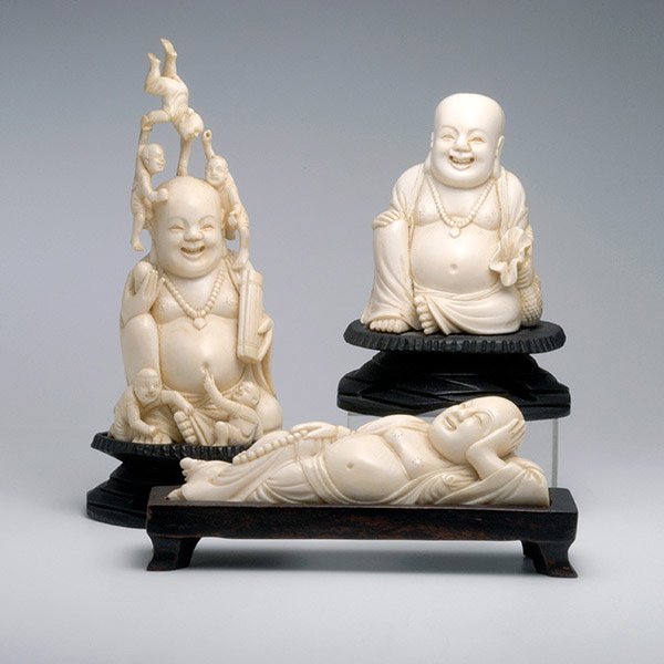 Three Ivory Carvings of Budai*, Republic Period: Three Ivory Carvings of Budai*, Including one of the Buddhist figure seated with his burlap bag, one of him with five boys, and the last depicting him in a reclining position. Republic Period, Tallest