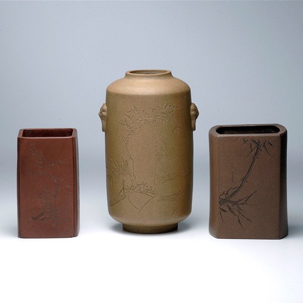 Three Yixing Clay Vessels: Three Yixing Clay Vessels, Comprising two square-form brush pots and a cyclindrical vase, all with incised decorations. Tallest: 7 1/8 inches (18.1 cm)