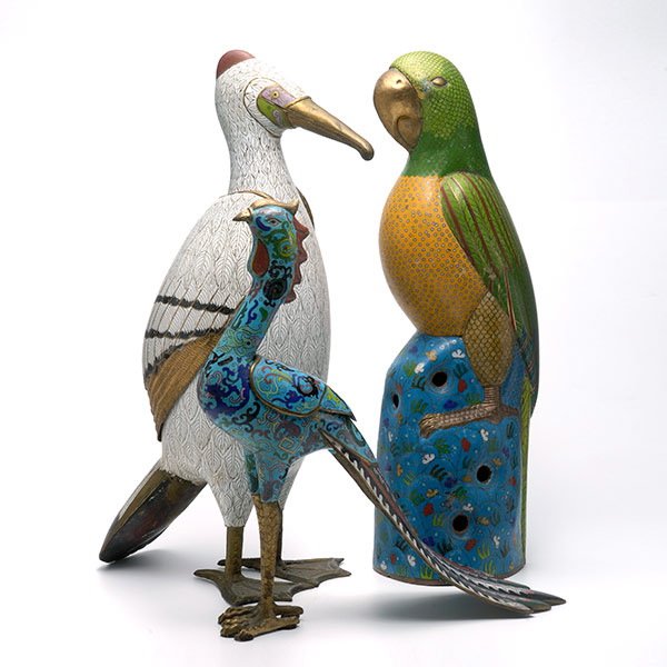 Three Cloisonné Enamel Birds: Three Cloisonné Enamel Birds, Comprising a white penguin, a parrot perched on a rock, and a peacock. Tallest: 19 3/4 inches (50.2 cm) [Minor wear and losses to the enamel, cracks. This condition repo