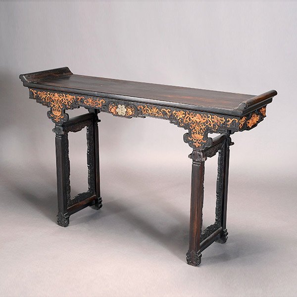 A Zitan Altar Table: A Zitan Altar Table, The aprons and sides overlaid with softwood carvings depicting peaches, lotus scrolls and bats suspending hanging ornaments, all surrounding an inlaid stone prosperity character, 