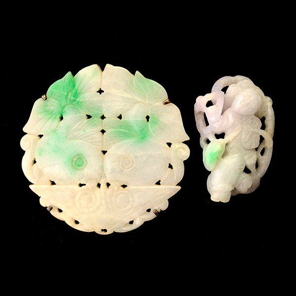 COLLECTION OF TWO JADE, SILVER ITEMS.: COLLECTION OF TWO JADE, SILVER ITEMS. Including one carved jadeite disc, set in a silver brooch together with a carved jadeite plaque depicting an Asian motif.