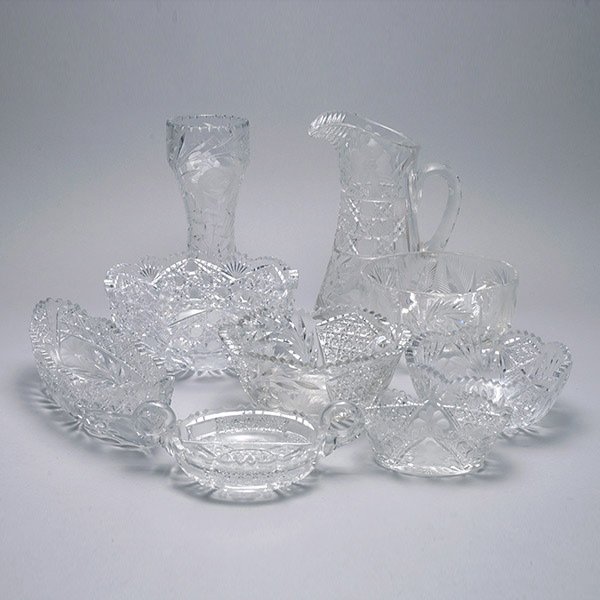 Nine American Brilliant Cut Glass Items: Nine Cut Glass Items with Etched Flowers: Pitcher {height 10 1/4 inches}; vase; three bowls {largest diameter 9 inches}; two boats; divided tray; and a tripod based bowl