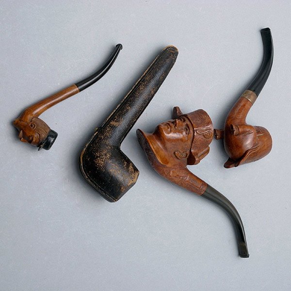 Three Vintage Briar Pipes:: Three Vintage Briar Pipes: one in the form of bust of Napoleon {length 7 inches}; the second in the form of a man's bottom with legs encased in a pair of boots; the third in form of a German man with