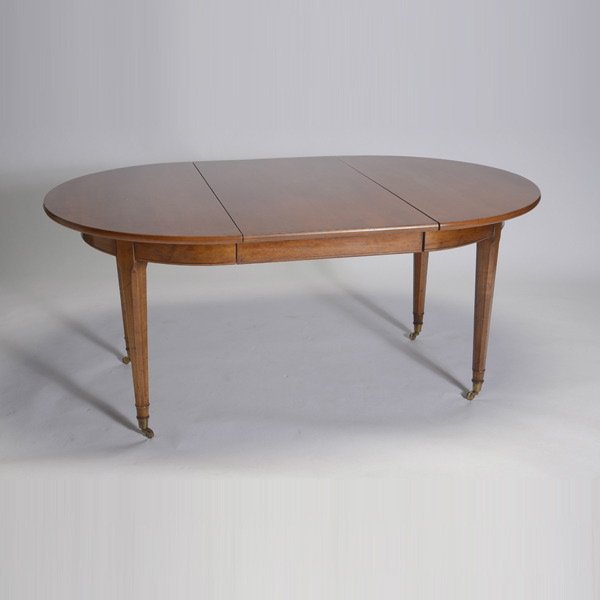 Brustlin Workshop Walnut Dining Table: Victorian Style Walnut Oval Dining Table, Brustlin Workshop, with three leaves and raised on caster feet {Height 28 3/4 inches; diameter 45 inches; width of each leaf 23 inches} [pads, leg for extensi