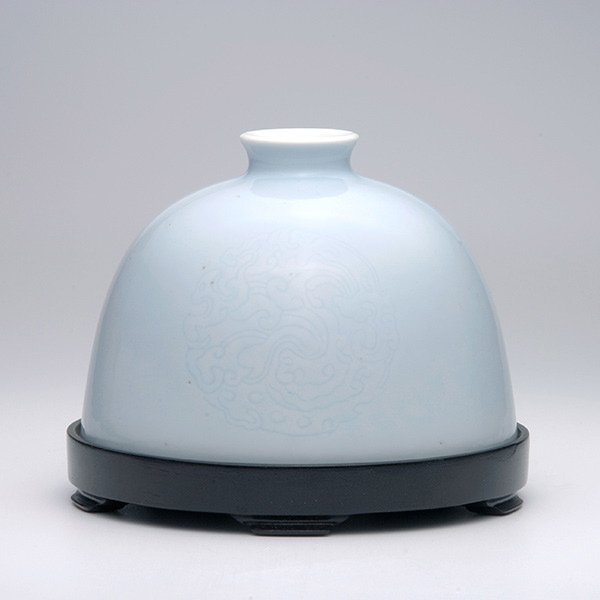 A Clair-de-Lune Glazed Washer: A Clair-de-Lune Glazed Washer, of domed shape delicately incised with decorative medallions, matching wood stand {Height: 3 1/2 inches (9 cm) excluding stand} [Repaired]