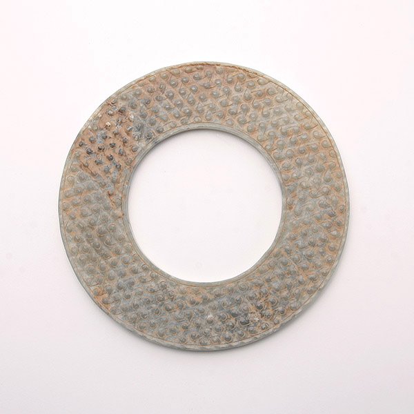A Jade Bi Disk, Late E. Zhou/W. Han Dynasty: A Jade Bi Disk, The pale greenish-grey jade bi disc finely carved in relief on both sides with comma spirals set within slightly raised borders Late Eastern Zhou/Western Han Dynasty, 3rd-2nd Century B