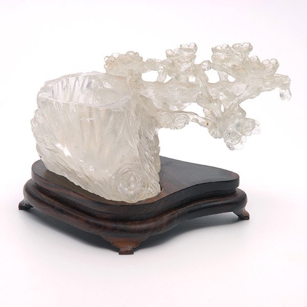 A Rock Crystal Brush Washer, 19th C.: A Rock Crystal Brush Washer, Carved in the form of a prunus tree trunk with a flowering branch, fitted wood stand. 19th Century, Length: 5 1/2 inches (14 cm) [Minute chips. This condition report state