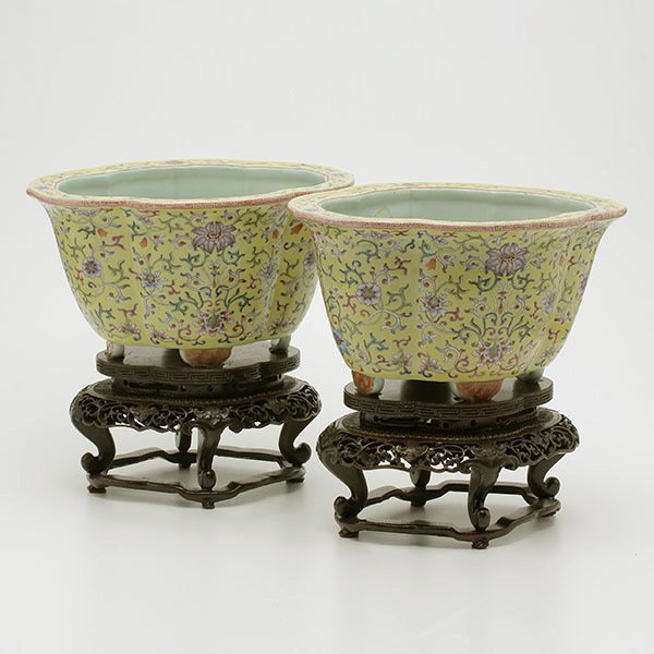 Pair of Famille Rose Footed Jardinieres, 19th C.: A Pair of Famille Rose Footed Jardinieres, Both of quatrefoil form, painted to the exterior with numerous meandering lotus sprays on a yellow ground, the base with two circular drainage holes and bear