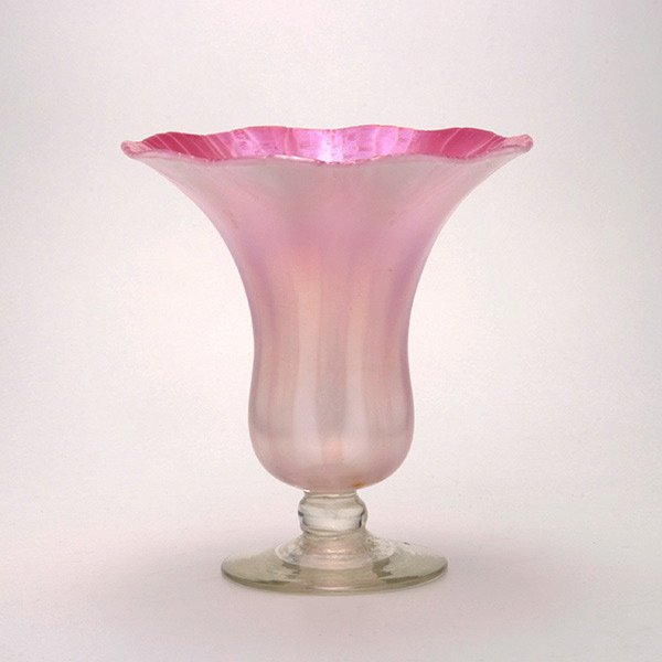 Tiffany Studios Pink Opalescent Favrile Vase: Tiffany Studios Pink Opalescent Favrile Vase. The inverted bell form with a flaring scalloped rim fashioned as a trumpet shape flower, the interior with a pink stretch iridescence, the exterior walls 