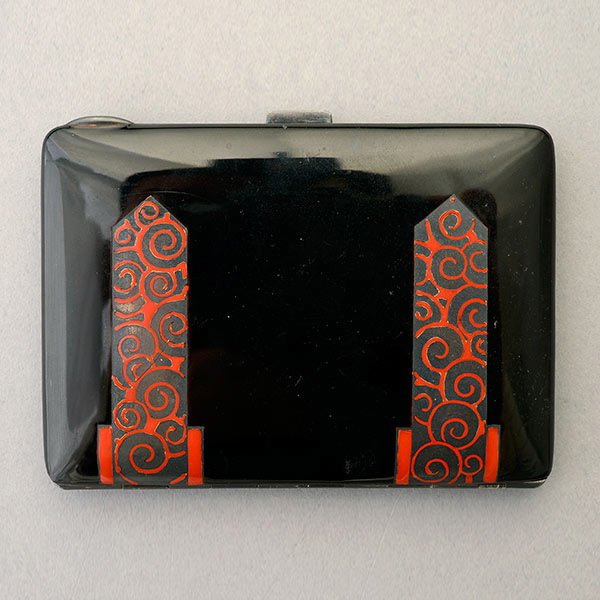MAPPIN ET WEBB PARIS, ENAMEL, STERLING BOX.: MAPPIN ET WEBB PARIS, ENAMEL, STERLING SILVER CIGARETTE BOX. Featuring a black enamel, accented by red enameled floral scrolled straps on front and back, the rectangle sterling silver pillow box measu