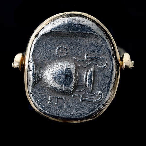 ANCIENT GREEK COIN, 14K YELLOW GOLD RING.: ANCIENT GREEK COIN, 14K YELLOW GOLD RING. Featuring one Boetian Drachma, set in a 14k yellow gold swivel mounting. {Size 7 1/4, Gross Weight: 12.9 dwts}