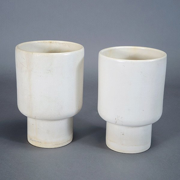 Two White Architectural Pots.: Two White Architectural Pots. By Malcolm Leland, manufactured by Gainey. Marked "USA Gainey Ceramics, Laverne, CA." Measures approximately 12 inches in diameter by 18 inches in height.