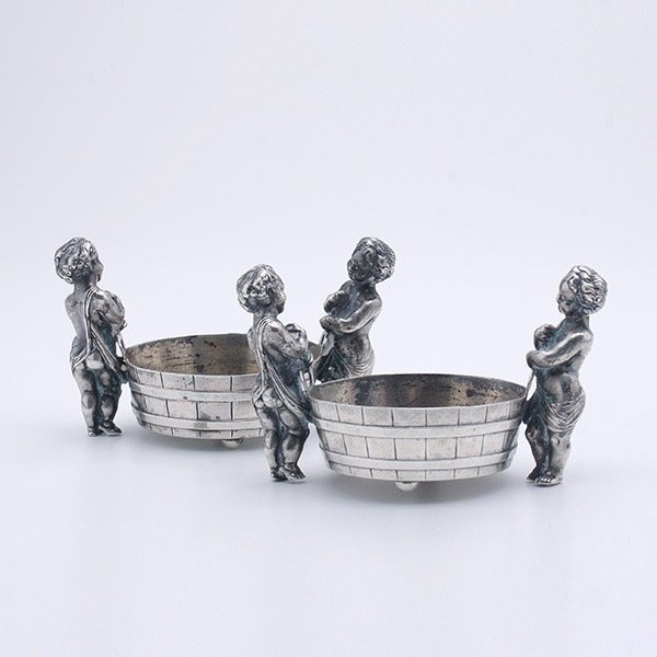 Pair of English Sterling Salt Cellars,: Pair of English Sterling Salt Cellars, Birmingham, Circa 1830, fashioned as buckets with twin standing cherub supports {Total silver weight 8.43 troy oz; height 2 inches; length 3 inches}