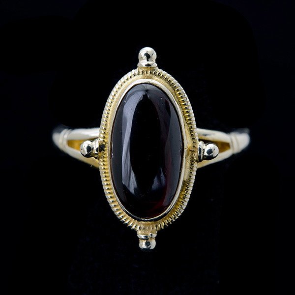 GARNET, 14K YELLOW GOLD RING.: GARNET, 14K YELLOW GOLD RING. Featuring one oval garnet cabochon measuring approximately 12 x 7 mm, set in a 14k yellow gold mounting. {Size 5, Gross Weight: 2.0 dwts}