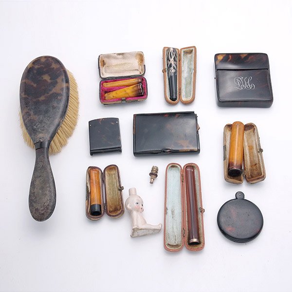 Tortoise Shell Dresser Items & Smoking Accessories:: Group of Tortoise Shell Dresser Items and Smoking Accessories: Comprising a tortoise shell brush {length 9 1/2 inches}, two cigarette cases, compact, and sewing implement; together with a Kewpie doll 