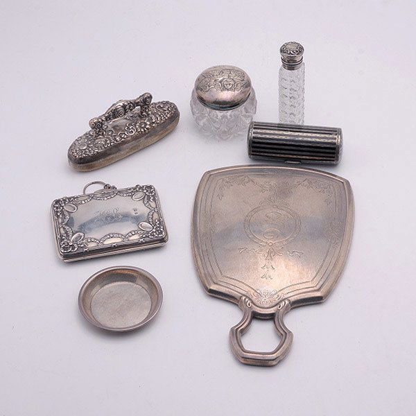 Group of Miscellaneous Sterling Dresser Items:: Group of Miscellaneous Sterling Dresser Items: a hand mirror {length 8 3/4 inches}; a small cylindrical scent bottle; an English purse fitted with a chain link, and a small dresser jar with repousse c