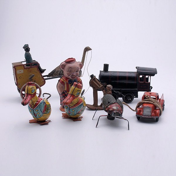 Lot of Tin Lithograph Toys:: Lot of Tin Lithograph Toys: Comprising two ducks {height 3 3/4 inches}, and a pig by J. Chein USA; ostrich driven cart, and a giant bug by Lehmann; windup train engine and tootsie toy truck; together 