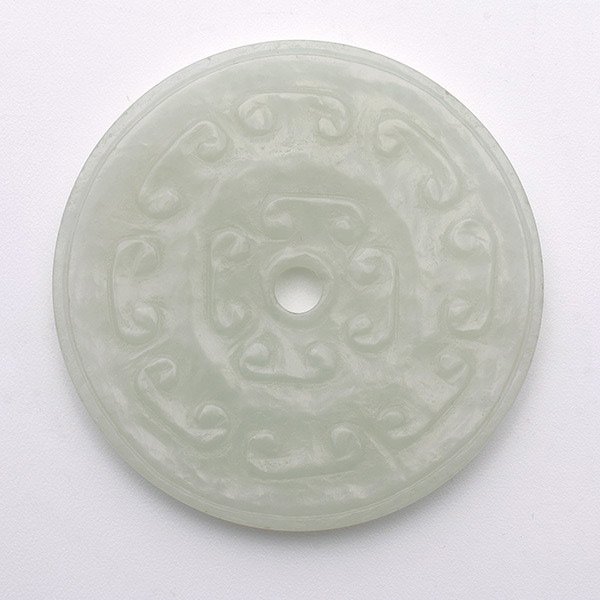 A White Jade Bi Disk, 18th/19th Century: A White Jade Bi Disk, Carved to one side with alternating ruyi-shaped motifs and dots, and the reverse carved with a field of tiny bosses between narrow inner and outer borders. 18th/19th Century, Dia
