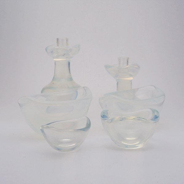 Suite of Orrefors Opalescent Glass:: Suite of Orrefors Opalescent Glass: Comprising four bowls {dimensions of largest 4 x 8 1/2 inches}; a pair of candlesticks {height 6 1/2 inches} (6)