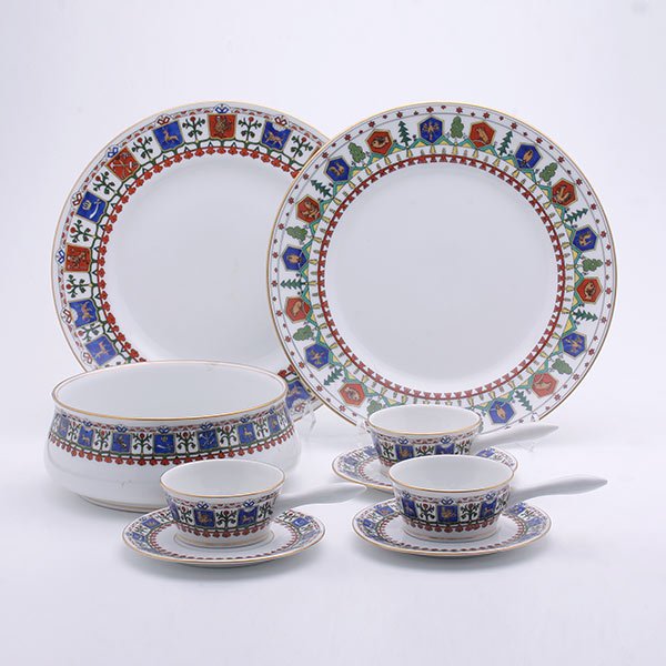 Kornilov Bros Porcelain Suite: Partial Suite of Kornilov Brothers Porcelains. Each ivory ground piece enclosed by an alternating border of flowering trees and the coat of arms for various cities in Russia, enclosed by a pendant bea
