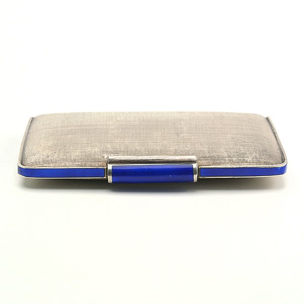Cartier Italian Enamel Sterling Compact: Cartier Art Deco Enamel Sterling Compact. The burnished rectangular form with a cobalt blue enamel band and a pressure lock thumb piece, opening to the interior compartment with a beveled mirrorplate,