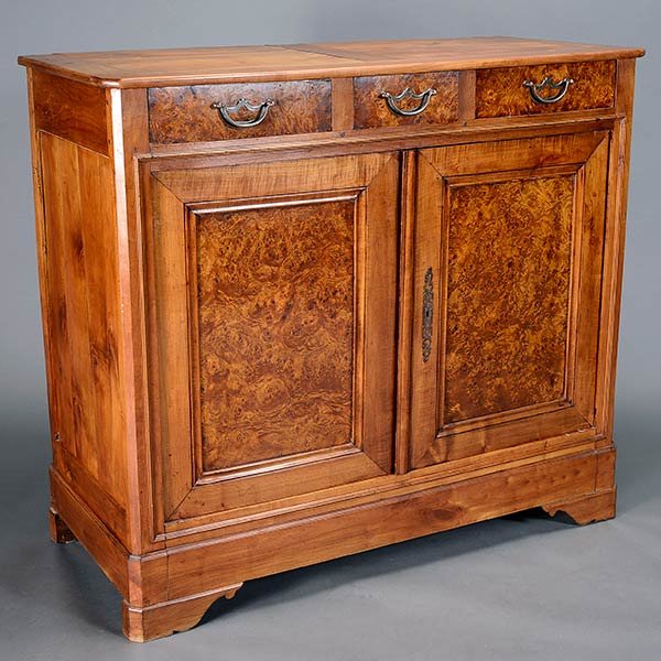 Biedermeier Bird's Eye Maple Buffet: Biedermeier Bird's Eye Maple Buffet. An out swept rectangular top over three side by side drawers, twin paneled doors, each with bird's eye maple veneer, opening to reveal an interior with one shelf w