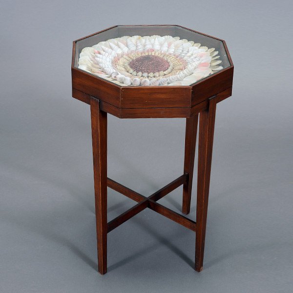 Sailor Art Shadow Box Table: American Sailor Art Vitrine Table. The octagonal sided shadow box top with a glazed panel enclosing a pictorial flowerhead pattern of shells, including scallops, rose petal tellin, snails, and spiral
