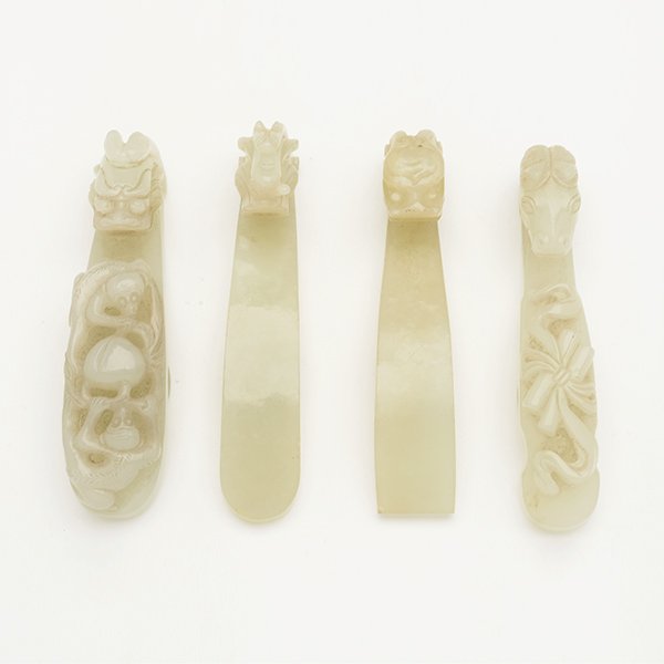 Four Jade Belt Hooks, 18th C.: Four Jade Belt Hooks Comprising three dragon-head hooks, with one featuring two monkeys approaching a peach along the top of the shaft; the fourth with a horse-head hook and a pair of ribbon-tied scro
