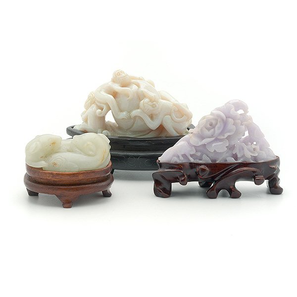 Three Hardstone Carvings, Qing: Three Hardstone Carvings The first a jade carving depicting twin badgers in opposition, the stone with small russet inclusions; the second an opal monkey group surrounding a giant peach; the third a p