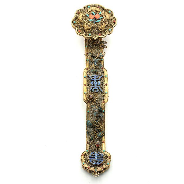 A Gilt-Metal Ruyi Scepter: A Gilt-Metal Ruyi Scepter With delicate scrolling filigree overlaid in turquoise, lapis, and other semiprecious stones to form reserves of peaches, two shou medallions, and butterfly and flower motifs
