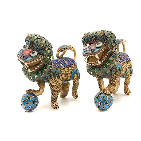 A Pair of Gilt-Silver Enameled Buddhist Lions, 20th: A Pair of Gilt-Silver Enameled Buddhist Lions Each of filigree construction with one foot resting on a ball, the movable head, mane and tail painted with vibrant enamels. 20th Century Length: 2 7/8 in