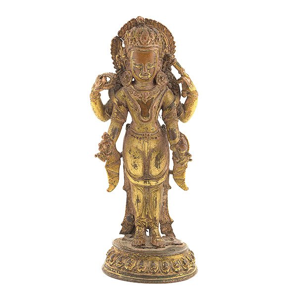 A Nepalese Gilt-Bronze Figure of Vishnu, 17th Century: A Nepalese Gilt-Bronze Figure of Vishnu The four-armed figure standing on a circular lotus base, holding a conch and disk in his upper hands and a lotus bud and mace in his lower hands, clad in a long