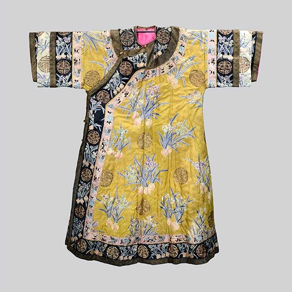 An Embroidered Lady's Robe, 19th Century: An Embroidered Lady's Robe The greenish-yellow ground embroidered in satin stitch with pastel colored narcissus plants interspersed by stylized longevity medallions in couched gilt-wrapped threads, th