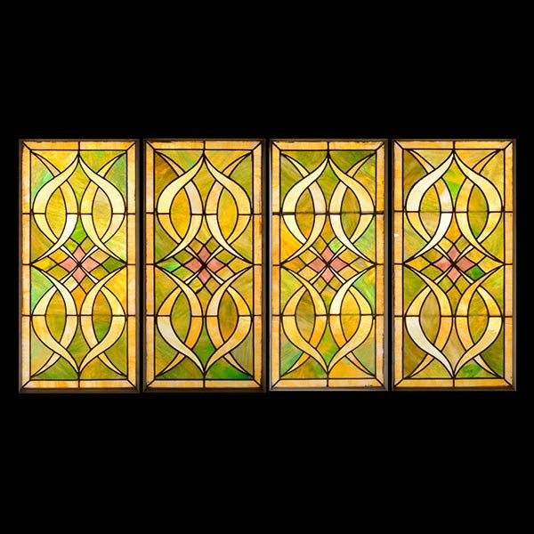 Set of Four Art Nouveau Slag Glass Panels: Set of Four Art Nouveau Slag Glass Panels, with mottled glass panels centering diamond medallions, in green purple, and caramel tones {Dimensions of one panel 40 1/2 x 20 inches} (4)