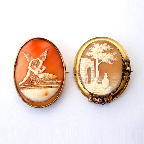 Collection of Two Victorian Shell Cameo, Gold-Filled: Collection of Two Victorian Shell Cameo, Gold-Filled Brooches. Including one measuring approximately 50 x 38 mm and depicting an angel embracing a maiden together with one measuring approximately 49 x