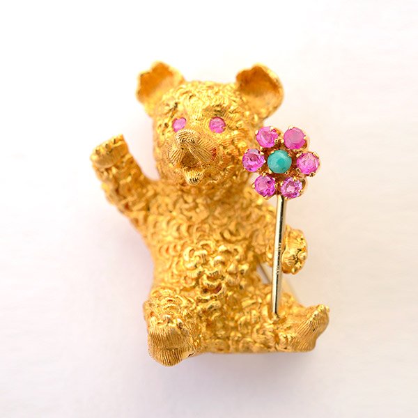 Sapphire, Chalcedony, 18k Yellow Gold Bear Brooch.: Sapphire, Chalcedony, 18k Yellow Gold Bear Brooch. Designed as a waving bear holding a flower measuring approximately 26.50 x 20.00 x 15.00 mm, accented by eight round-cut sapphires weighing a total o