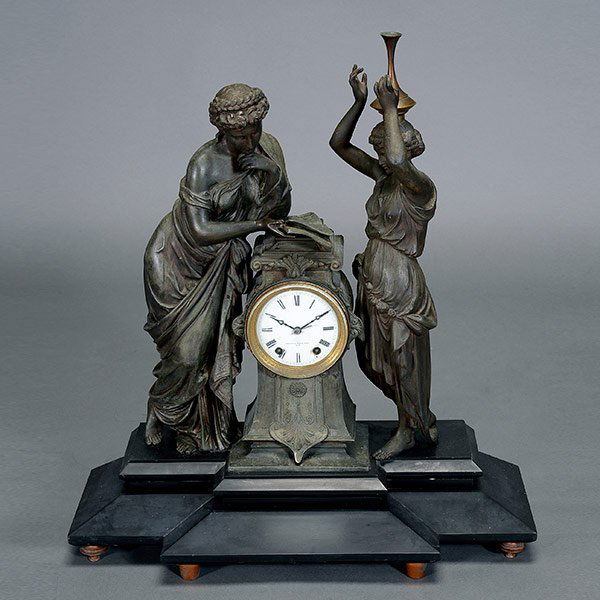 Seth Thomas Spelter Figural Mantle Clock: Seth Thomas Spelter Figural Mantle Clock in the Aesthetic Style, retailed by Mitchell Vance & Co. NY, mounted on slate base {Height 23 inches; length 21 inches} [breaks, and repairs to figures] [pendu