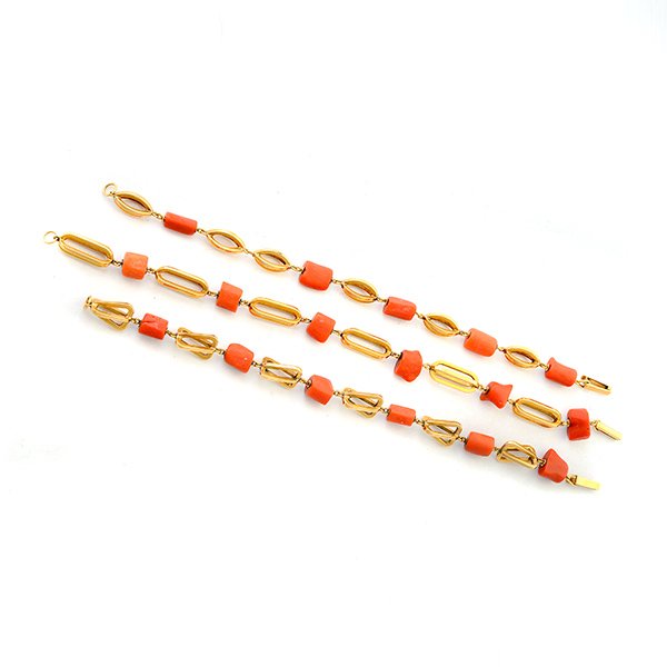 *Collection of Three Coral, 14k Yellow Gold Bracelets.: *Collection of Three Coral, 14k Yellow Gold Bracelets. The three fancy link bracelets measuring approximately between 8 to 8 1/2 inches in length and alternating between branch coral beads and 14k yel