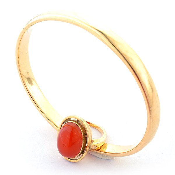 Carnelian, 14k Yellow Gold Jewelry Suite.: Carnelian, 14k Yellow Gold Jewelry Suite. Including one oval carnelian cabochon, 14k yellow gold ring, size 5 together with a 14k yellow gold hollow bangle bracelet. {Gross Weight: 10.7 dwts}